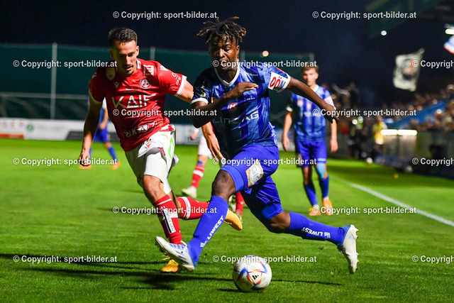 AUT, 2.Liga, FC Blau Weiss Linz vs GAK 1902 | 12.08.2022, Hofmann Arena Linz, AUT, 2.Liga, FC Blau Weiss Linz vs GAK 1902, im Bild Paul Mensah (Blau Weiss Linz) vs Michael Lang (GAK)



// Admiral 2. Liga Match between FC Blau Weiss Linz and GAK 1902 in Linz, Austria on 2022/08/12
