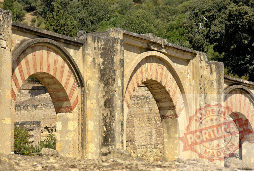 Madinat al-Zahra arches retaining wall Caliphate of Cordoba. Spain - Cordoba | Madinat al-Zahra archaeological ruins with striped horseshoe arches under sunlight - Realized with Pictrs.com