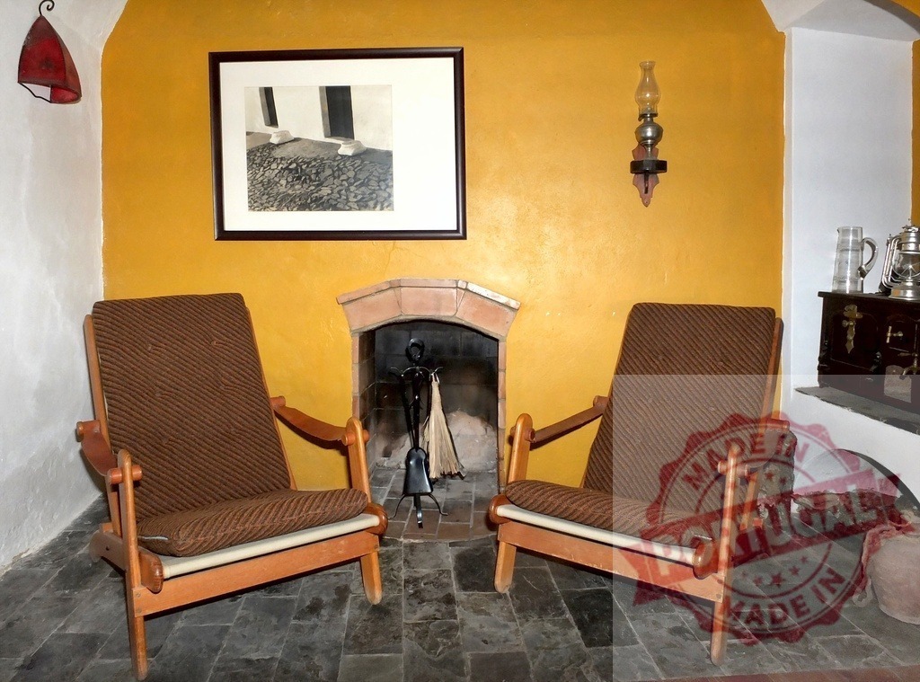 Cozy living room interior with rustic fireplace and yellow wall | Inviting rustic living room with two comfortable armchairs facing a traditional fireplace - Realisiert mit Pictrs.com