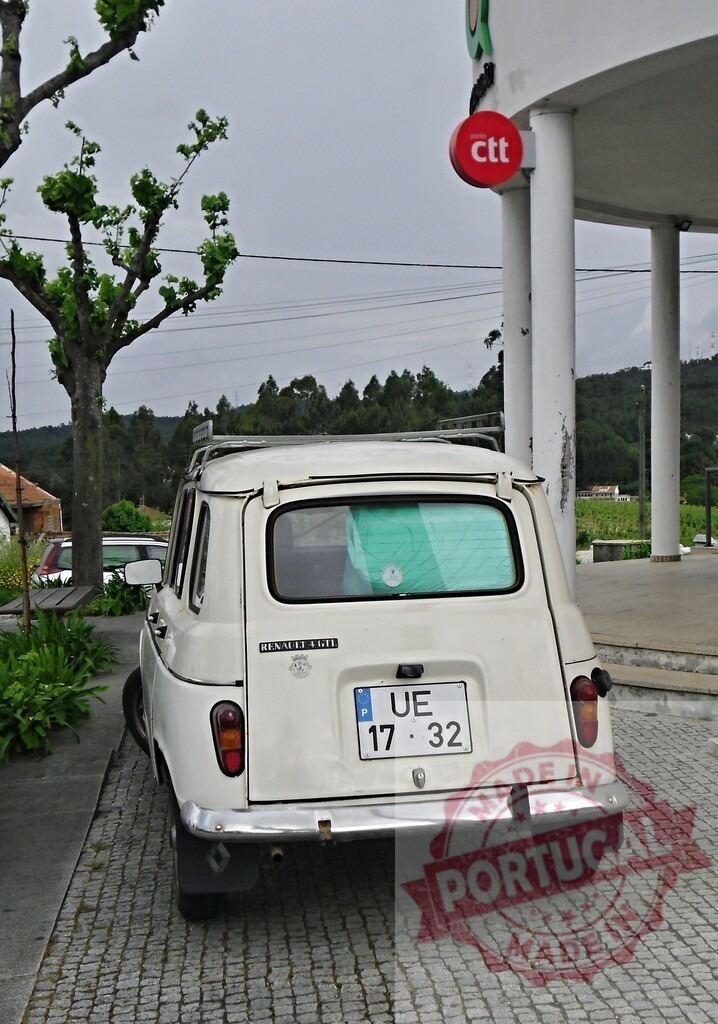 White Renault 4L vintage car parked in Portugal | Vintage Renault 4L car parked on cobblestone street next to CTT Post Office building - Realized with Pictrs.com