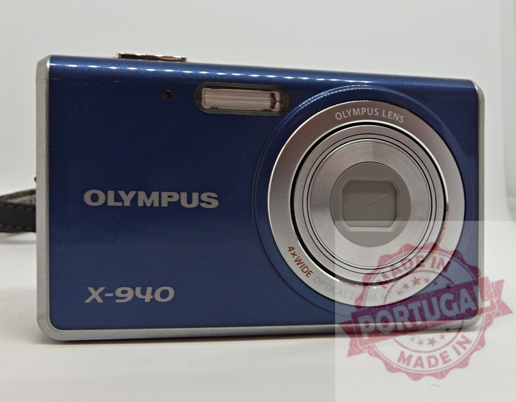 Olympus X-940 blue digital point and shoot camera | Blue Olympus X-940 digital point and shoot camera, showcasing vintage electronic photography technology - Realized with Pictrs.com