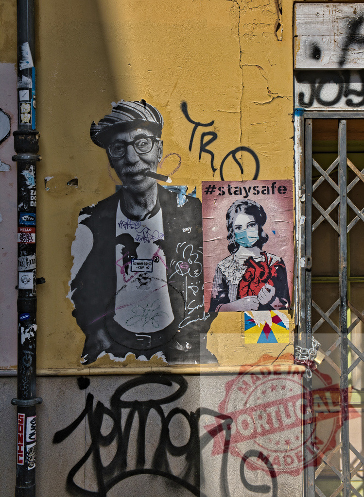 Urban street art posters showing social messages | Street wall featuring graffiti, an old man poster and a girl wearing a mask holding a heart - Realisiert mit Pictrs.com