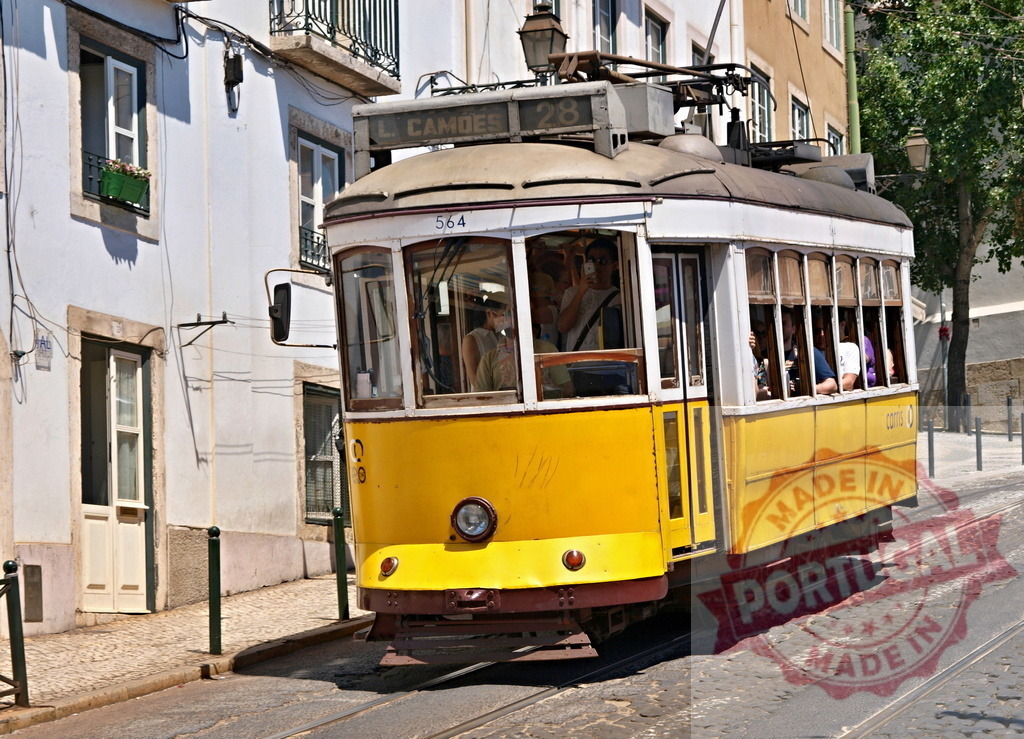 Yellow Lisbon Tram Number 28 Climbing up a Narrow Street in Alfama District | Yellow funicular number 28 climbing up a narrow street in Lisbon's Alfama district, carrying tourists - Realisiert mit Pictrs.com