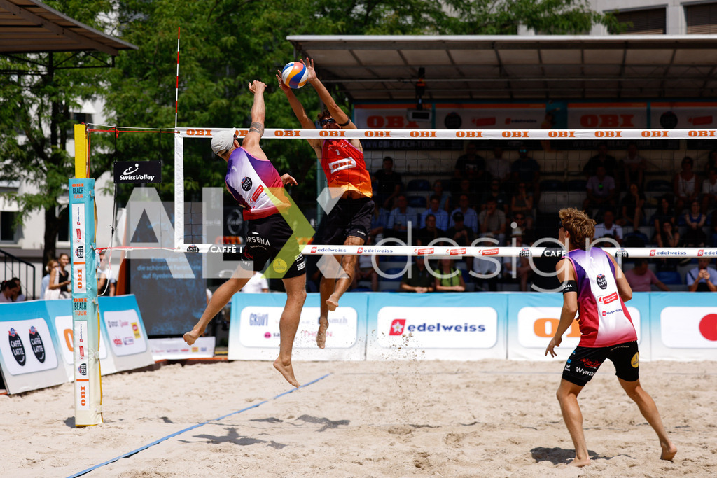 Obi BeachTour 2026 - Basel | BASEL, SWITZERLAND - JULY 17: DANIEL ALLEMANN (SUI) attack / spike against NOAH YANNIK ALOIS FURRER (SUI) blocking during the Obi BeachTour 2026 match between ALLEMANN / LEFFLER (SUI) and FURRER / WYMANN (SUI) at Barfüsserplatz on July 17, 2026 in Basel, Switzerland. - Realisiert mit Pictrs.com