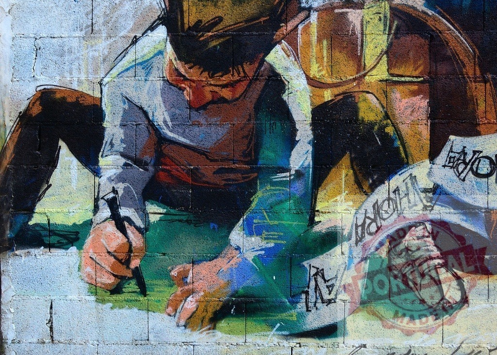 Graffiti artist drawing on a wall with a marker | Young artist drawing graffiti art on a brick wall - Realized with Pictrs.com