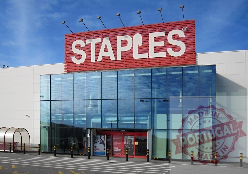 Staples storefront building with large glass windows | Staples store exterior on a sunny day with blue sky, showcasing the brand and commercial retail - Realized with Pictrs.com