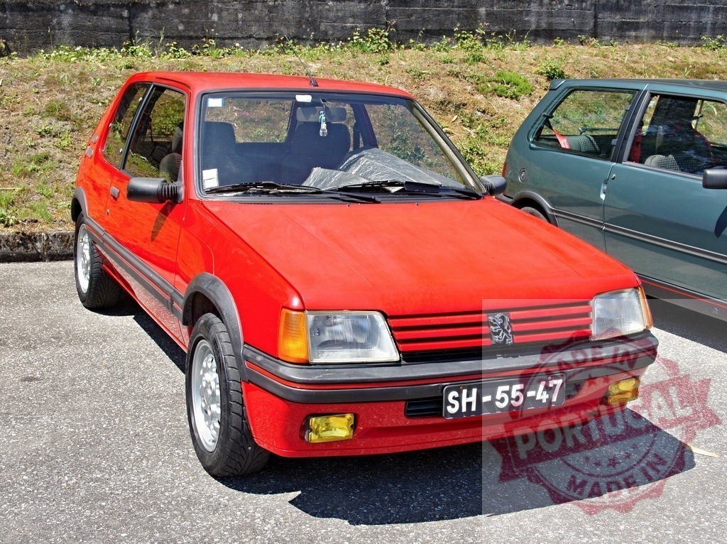 Red Peugeot 205 GTI parking in a parking lot | Shiny red Peugeot 205 GTI parked in a parking lot, a classic french hot hatch - Realized with Pictrs.com