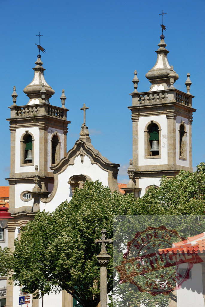 Church of São Marcos and baroque bell towers in Braga, Portugal. Region Norte - Portugal | Church of São Marcos showing baroque bell towers, crosses, and trees under a clear blue sky - Realized with Pictrs.com