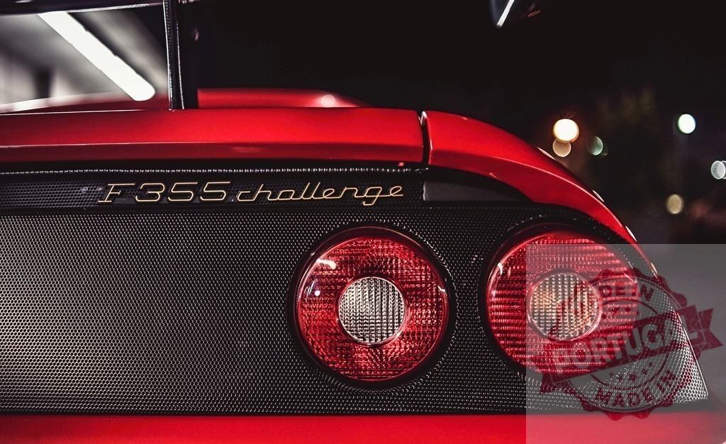 Ferrari F355 Challenge rear lights glowing at night | Ferrari F355 Challenge sports car displaying its red taillights and exhaust grill at night - Realized with Pictrs.com