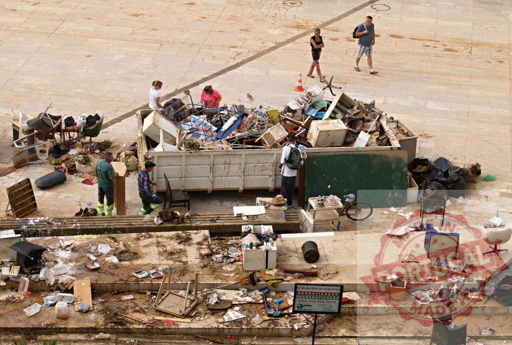 Cleanup after severe flood disaster in Albufeira | Albufeira Flood - discruction by weather problems People cleaning up debris and damaged furniture after a natural disaster flood - Realized with Pictrs.com