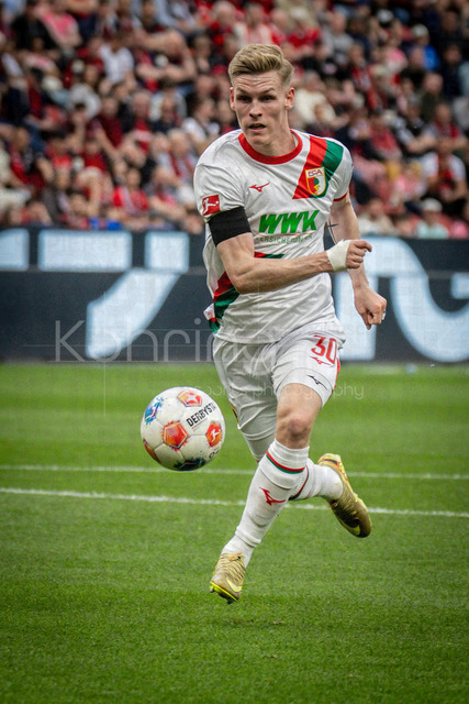 German Bundesliga, Bayer 04 Leverkusen vs. FC Augsburg, 18.04.2026 | LEVERKUSEN, GERMANY - APRIL 18, 2026 :  Anton Kade (FC Augsburg, 30) during the German Bundesliga match on gameday 30 between Bayer 04 Leverkusen vs. FC Augsburg at BayArena on April 18, 2026 in Leverkusen, Germany. DFL REGULATIONS PROHIBIT ANY USE OF PHOTOGRAPHS AS IMAGE SEQUENCES AND/OR QUASI-VIDEO.