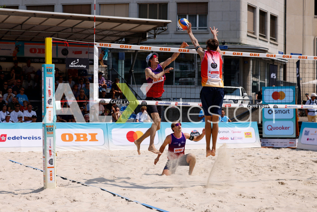 Obi BeachTour 2026 - Basel | BASEL, SWITZERLAND - JULY 19: SIMON HAGENBUCH (SUI) attack / spike against LUC EMANUEL FLÜCKIGER (SUI) during the Obi BeachTour 2026 match between DILLIER / FLÜCKIGER (SUI) and HAGENBUCH / HAUSSENER (SUI) at Barfüsserplatz on July 19, 2026 in Basel, Switzerland. - Realisiert mit Pictrs.com