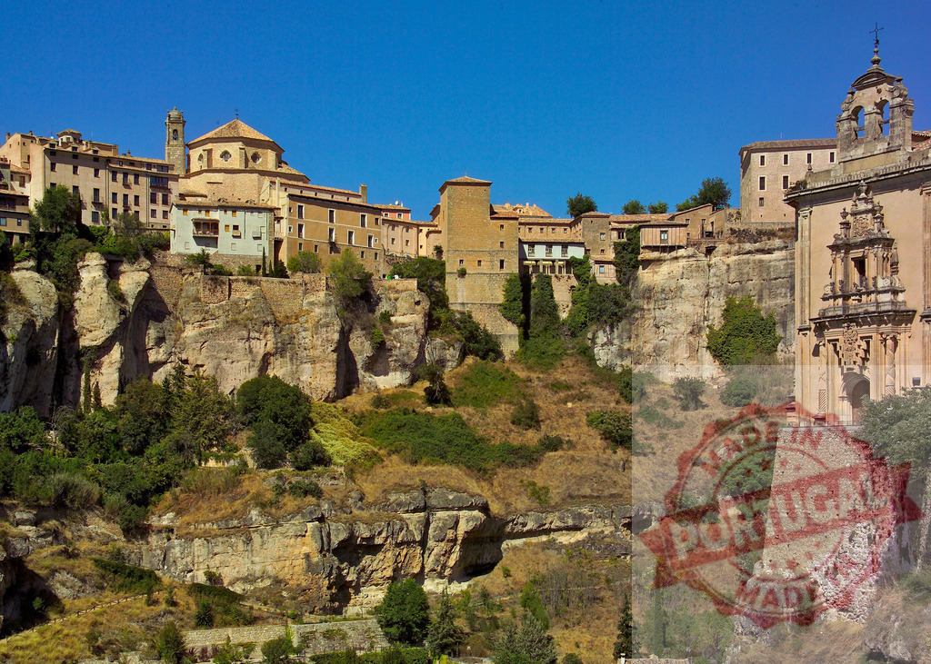 Cuenca city with historic hanging houses on cliff. Cuenca - Spain | Cuenca's old town perched on a steep cliff, showcasing historic architecture under a clear sky - Realized with Pictrs.com