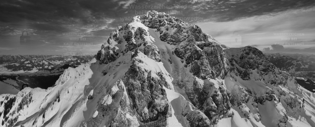 The natural horn black & white edition | Winter aerial shot of the snow covered mountain peak Kitzbühler Horn in the warm sunlight of evening sunset. Natural look with no peak signs on top. - Realisiert mit Pictrs.com