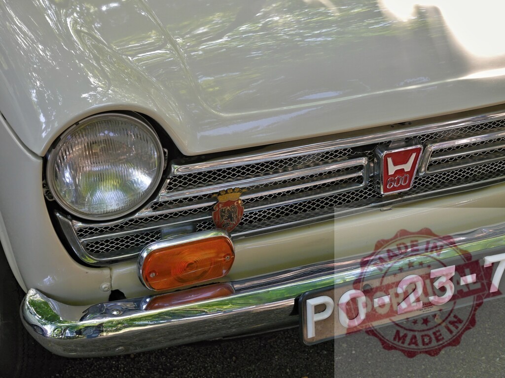 Honda N600 vintage compact car front detail | Front detail of classic Honda N600 car grille, headlight, and license plate - Realized with Pictrs.com