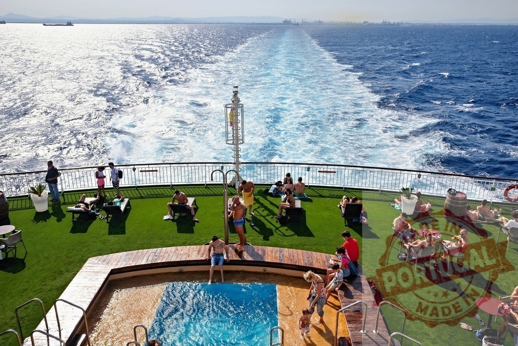 Cruise ship deck with people relaxing by the pool | People enjoying leisure time and swimming on a sunny cruise ship deck at sea - Realized with Pictrs.com