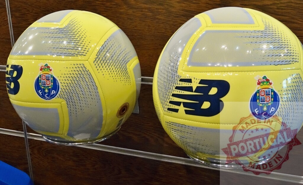 FC Porto football balls displaying team logo and New Balance branding | FC Porto soccer balls in yellow and gray color scheme with club crest and New Balance logo - Realized with Pictrs.com