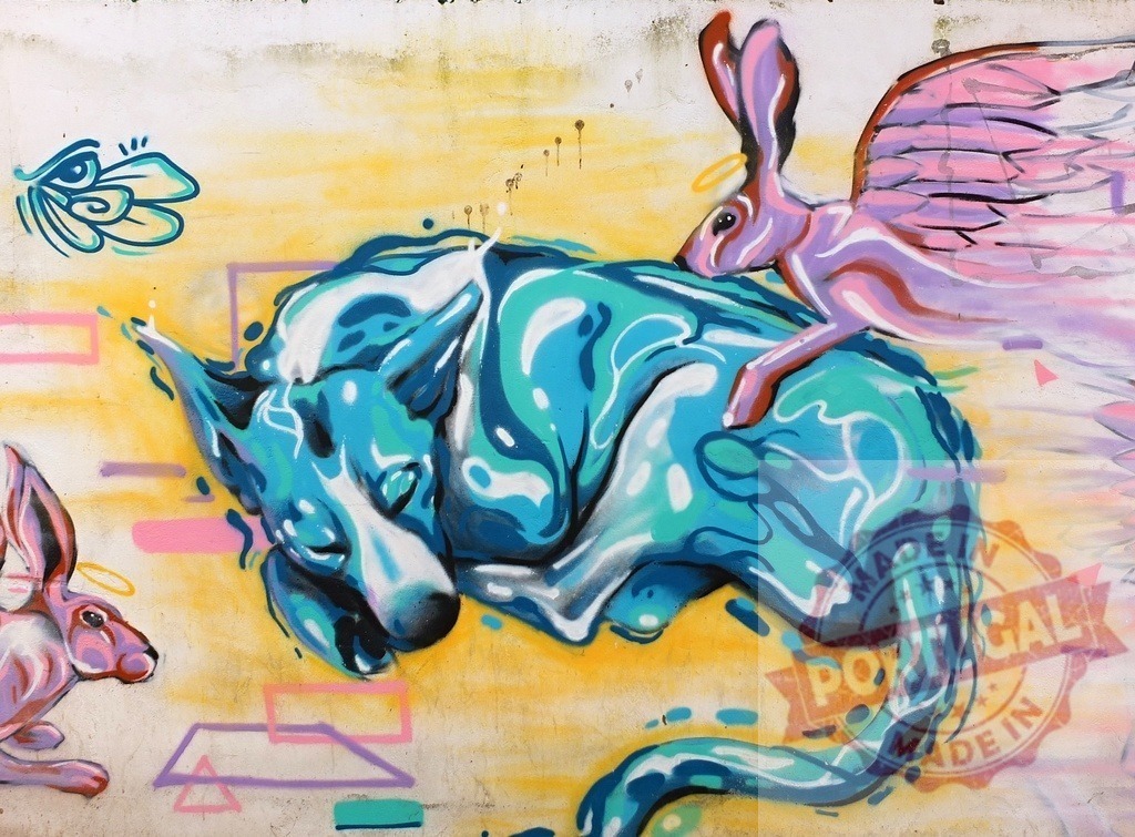 Sleeping wolf dog mural with flying rabbit street art | Vivid street art showing a sleeping wolf and a winged rabbit with halo on a wall - Realized with Pictrs.com