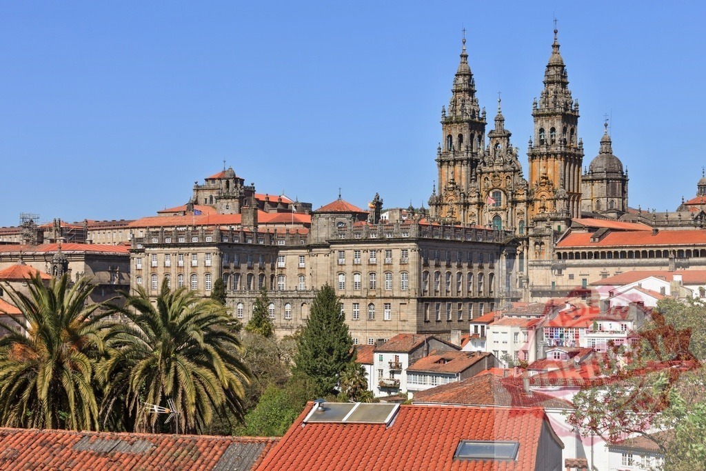 Santiago de Compostela Cathedral with historic city skyline Spain. Galicia - Spain | Santiago de Compostela Cathedral towers over the historic city buildings and rooftops under a clear sky - Realisiert mit Pictrs.com