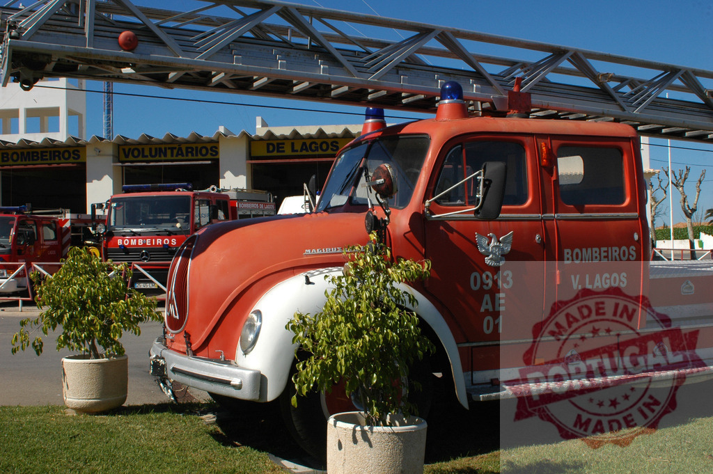 Vintage Magirus-Deutz fire engine at Portuguese fire station | Red classic fire truck parked outdoors at a Bombeiros Voluntários de Lagos station - Realized with Pictrs.com