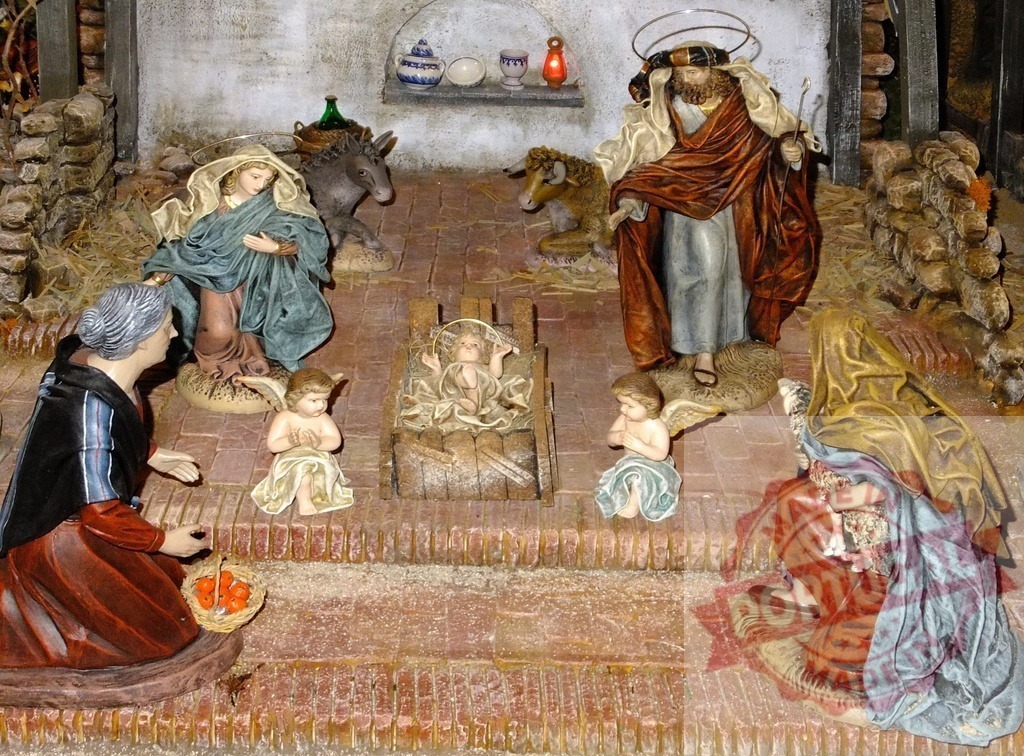 Nativity scene showing Baby Jesus, Mary, Joseph, angels and shepherds praying | Christmas nativity scene representing the birth of Jesus with figurines of Mary, Joseph, angels and shepherds - Realized with Pictrs.com