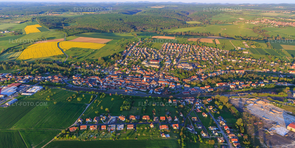 Aerial view: Overview of locations from the west in Diemeringen in the state Bas-Rhin, France. – Photo: IMG_145873.jpg taken on 04/30/2025 by Werner Riehm/FLY-FOTO.com – Resolution of the original: 5412 x 2732 px