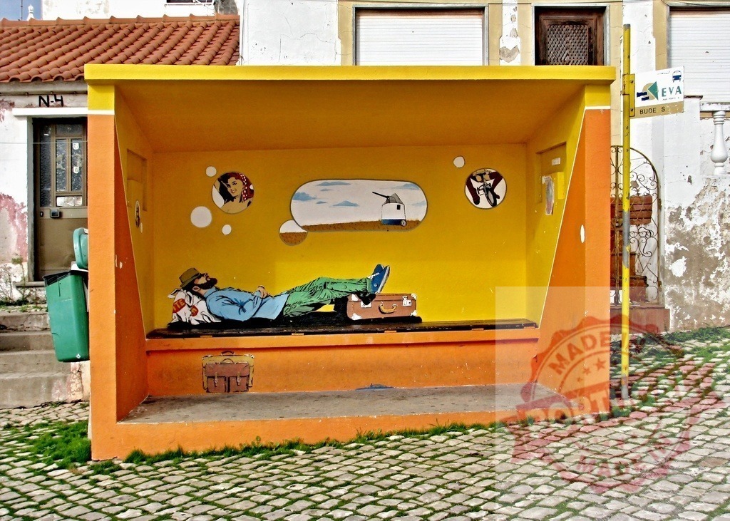 Traveler sleeping in a colorful bus stop dreaming of a woman, a windmill and a bicycle | Traveler sleeping on a bench inside a colorful bus stop with cartoon dreams painted on the wall - Realized with Pictrs.com