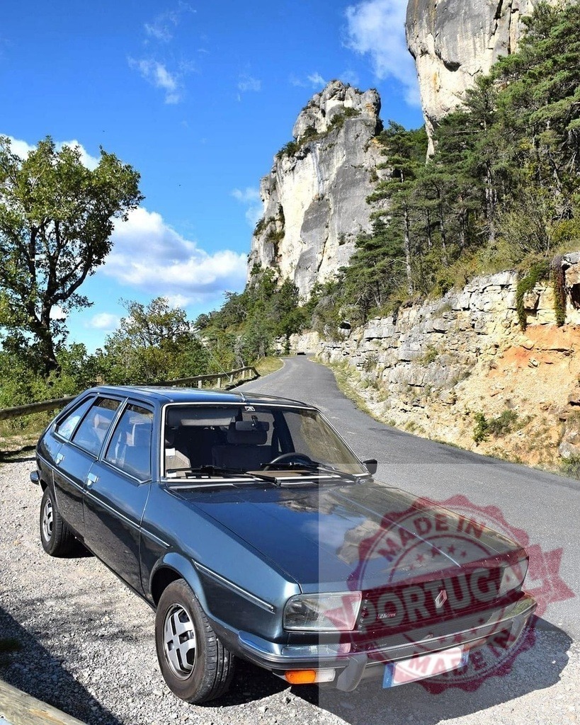 Renault 20 vintage car traveling scenic mountain road | Renault 20 hatchback parked on a gravel shoulder beside a winding mountain road - Realized with Pictrs.com
