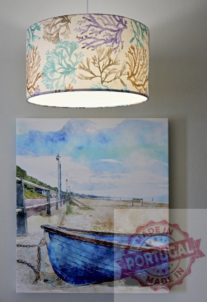 Lampshade with coral pattern and beach watercolor wall art | Coastal style interior showing a patterned lampshade and a watercolor painting of a blue boat on a beach - Realized with Pictrs.com