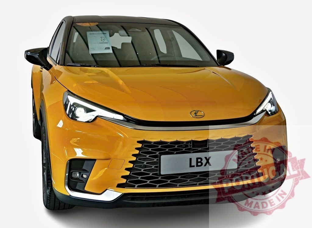 Lexus LBX showcasing its bold design and illuminated headlights | Front view of a golden Lexus LBX, highlighting its distinctive honeycomb grille and sleek, modern design - Realisiert mit Pictrs.com