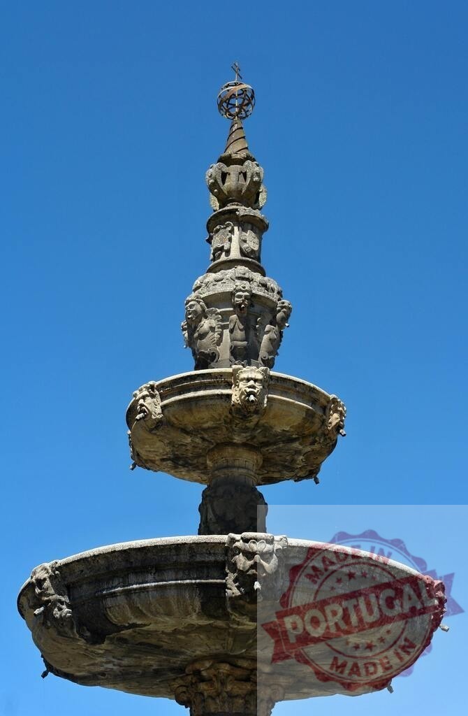 Baroque fountain of the horses sculpture in Santiago de Compostela. Norte - Portugal | Elaborate stone fountain featuring carved faces and a globe against a blue sky - Realisiert mit Pictrs.com