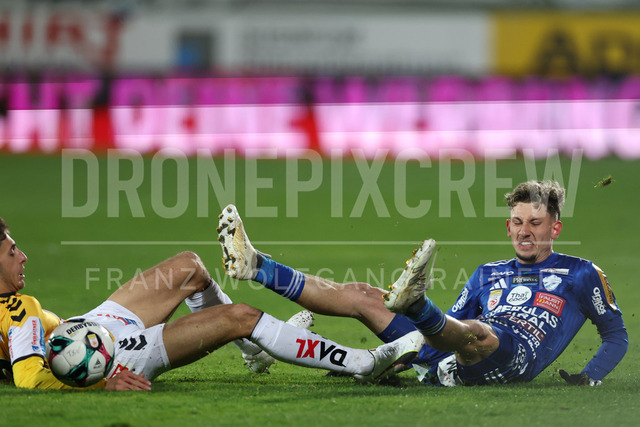TSV Egger Glas Hartberg vs SV Oberbank Ried – Austrian Bundesliga Match | The image shows Ante Bajic (Ried) make a foul on Damjan Kovacevic (Hartberg), at the Bundesliga match TSV Hartberg vs SV Ried at Profertil Arena Hartberg. 22.11.2025