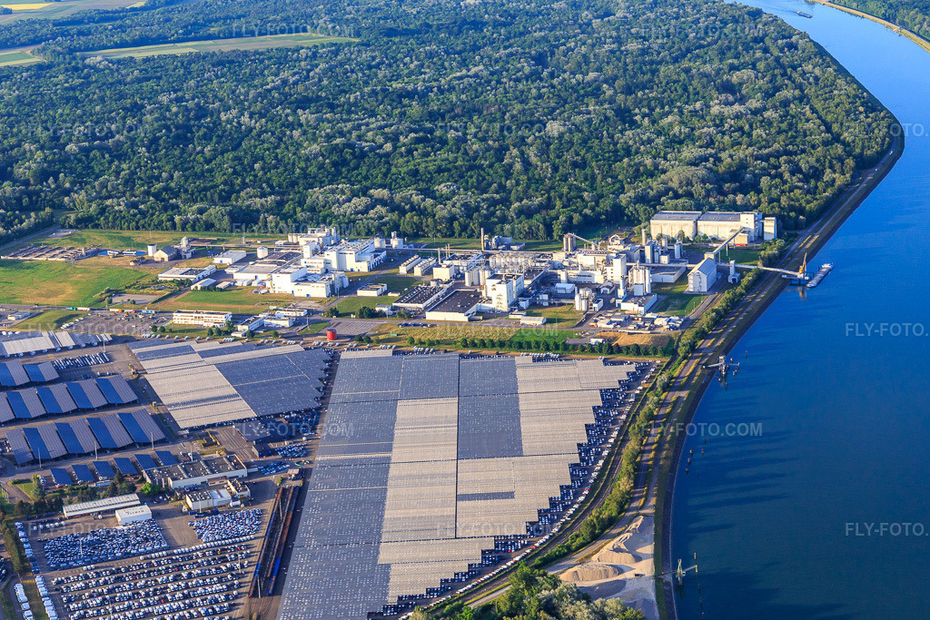 Aerial view: Zone Industrielle et Portuaire with industrial facilities on the Rhine of Jungbunzlauer SA and TEREOS Starch & Sweeteners Europe in front of the car depot of CEVA Logistics in Marckolsheim in the state Bas-Rhin, France. – Photo: IMG_147391.jpg taken on 05/29/2025 by Werner Riehm/FLY-FOTO.com – Resolution of the original: 5400 x 3600 px – Jungbunzlauer - Your partner for ingredient excellence – Groupe coopératif sucrier français - Tereos – WWW.CEVALOGISTICS.COM