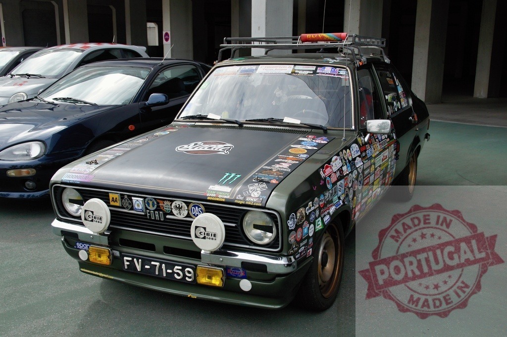 Customized Ford Escort Showing Many Stickers Parked in Garage | Classic Ford Escort featuring numerous stickers and modifications parked in a garage - Realized with Pictrs.com
