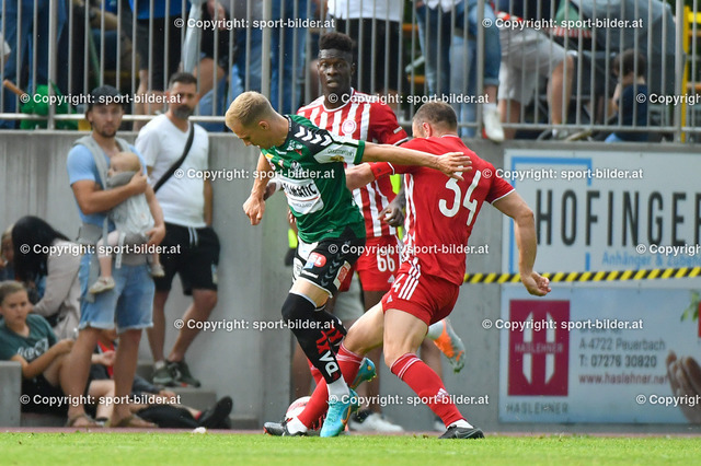 AUT, SV Ried (AUT) vs Olympiakos FC (GRE), Testspiel, Vorbereitung 2022-23 | 24.06.2022, Guntamatic  Arena Peuerbach, AUT, Testspiel Vorbereitung 2022-23, SV Ried (AUT) vs Olympiakos FC (GRE),  im Bild Christoph Monschein (Ried) vs Pape Abou Cisse (Olympiacos FC), Avraam Papadopoulos (Olympiacos FC)

// Test Match, New Season 2022-23 SV Ried (AUT) vs Olympiakos FC (GRE) in Peuerbach, Austria on 2022/06/24