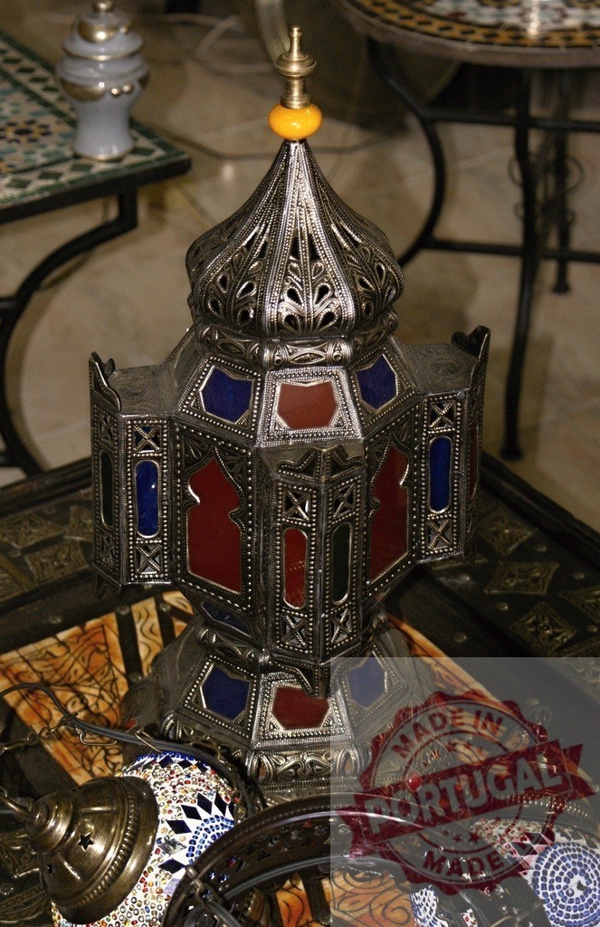 Moroccan Arabic lamp with stained glass decorating a bazaar stall | Ornate metalwork lantern with colorful stained glass panels and filigree detail for sale - Realized with Pictrs.com