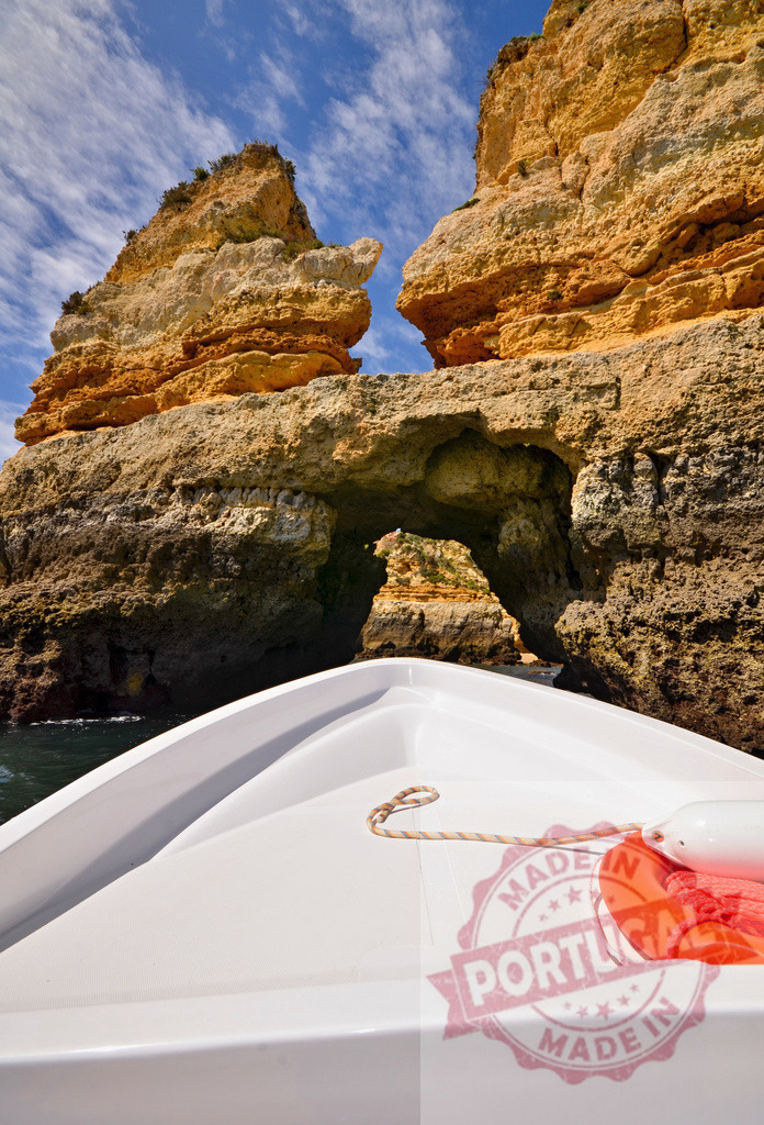 Boat entering sea cave at Ponta da Piedade | Small boat exploring the rock formations and sea caves along the Algarve coastline - Realized with Pictrs.com