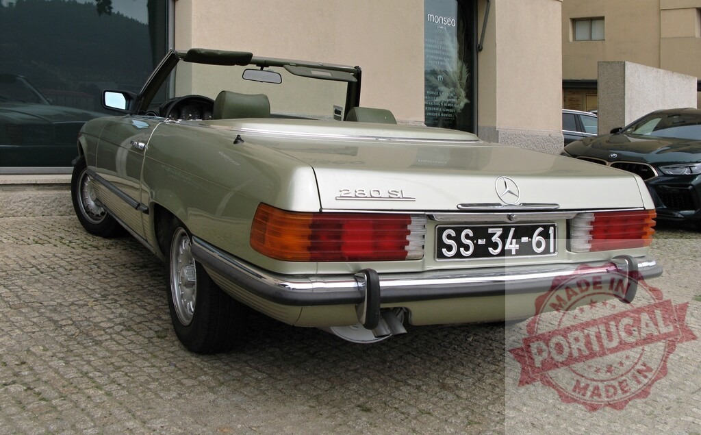 Mercedes-Benz 280 SL parked near dealership | Classic Mercedes-Benz 280 SL convertible parked on cobblestone street - Realized with Pictrs.com