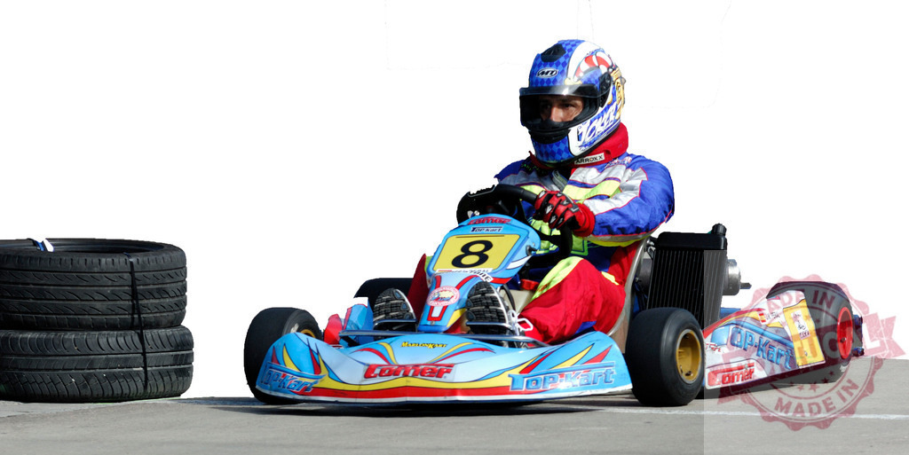 Kart driver racing on a go-kart track with spare tires | Professional kart driver racing on a go-kart track with spare tires, ready for a pit stop - Realisiert mit Pictrs.com
