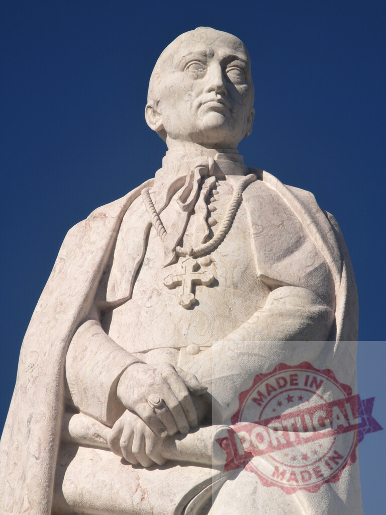 Marble statue of religious figure looking up | White marble statue of a bishop or cardinal holding a scroll against a clear blue sky - Realized with Pictrs.com