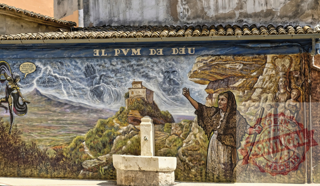 Mural painting depicting God, lightning, and villagers in Spain | Colorful mural depicting a mythical scene with God, lightning, and people in a village landscape - Realisiert mit Pictrs.com