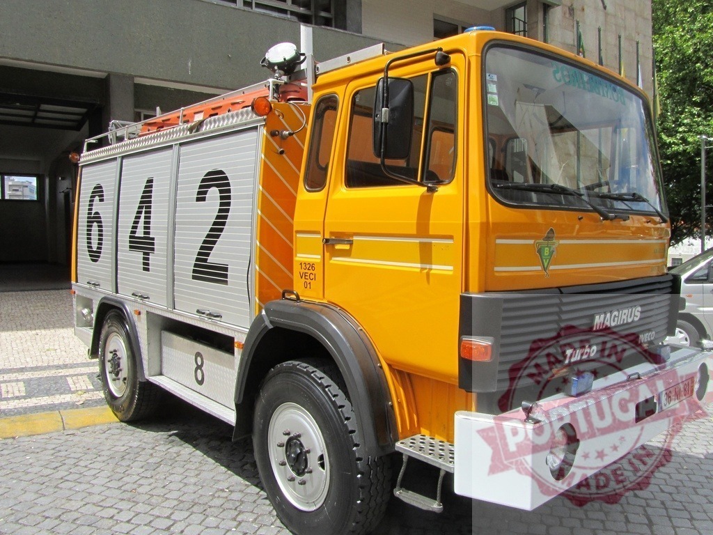 Yellow Magirus Iveco fire engine truck parking | Yellow Magirus Iveco fire truck parked on cobblestone street during daytime - Realized with Pictrs.com