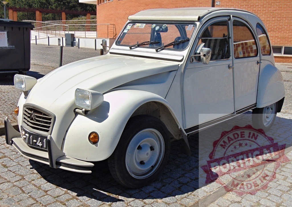 White Citroën 2CV parked on cobblestone street in sunny day | Classic white Citroën 2CV parked in a paved area on a sunny day, showcasing its iconic design - Realized with Pictrs.com