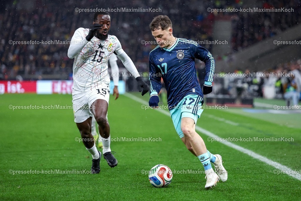 DFB30032600079 | 30.03.2026, Fußball, Länderspiel, Deutschland - Ghana, MHP-Arena (Stuttgart), Saison 2025 2026: Elisha Owusu (Ghana #15) im Zweikampf gegen  Florian Wirtz (GER #17)  DFB regulations prohibit any use of photographs as image sequences and or quasi-video.