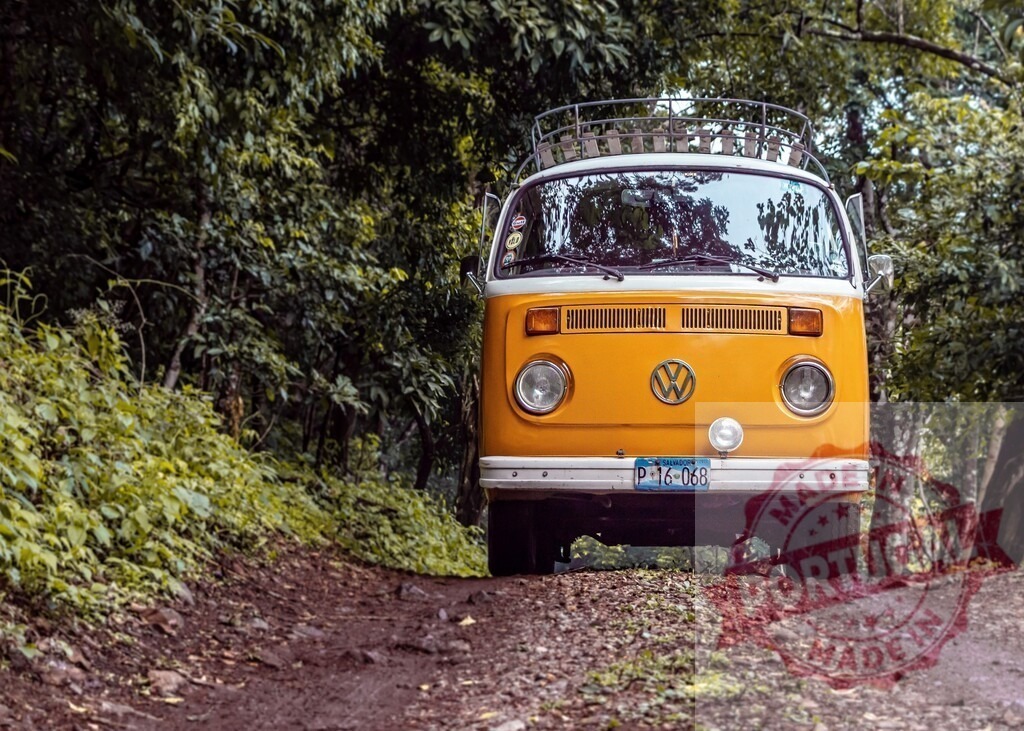 Volkswagen van traveling dirt road through forest | Yellow Volkswagen camper van driving on an off-road track, exploring nature - Realized with Pictrs.com