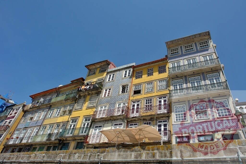 Colorful buildings and traditional architecture in Ribeira, Porto. Porto - Portugal | Colorful tiled and painted residential buildings lining the waterfront in Ribeira, Porto - Realized with Pictrs.com