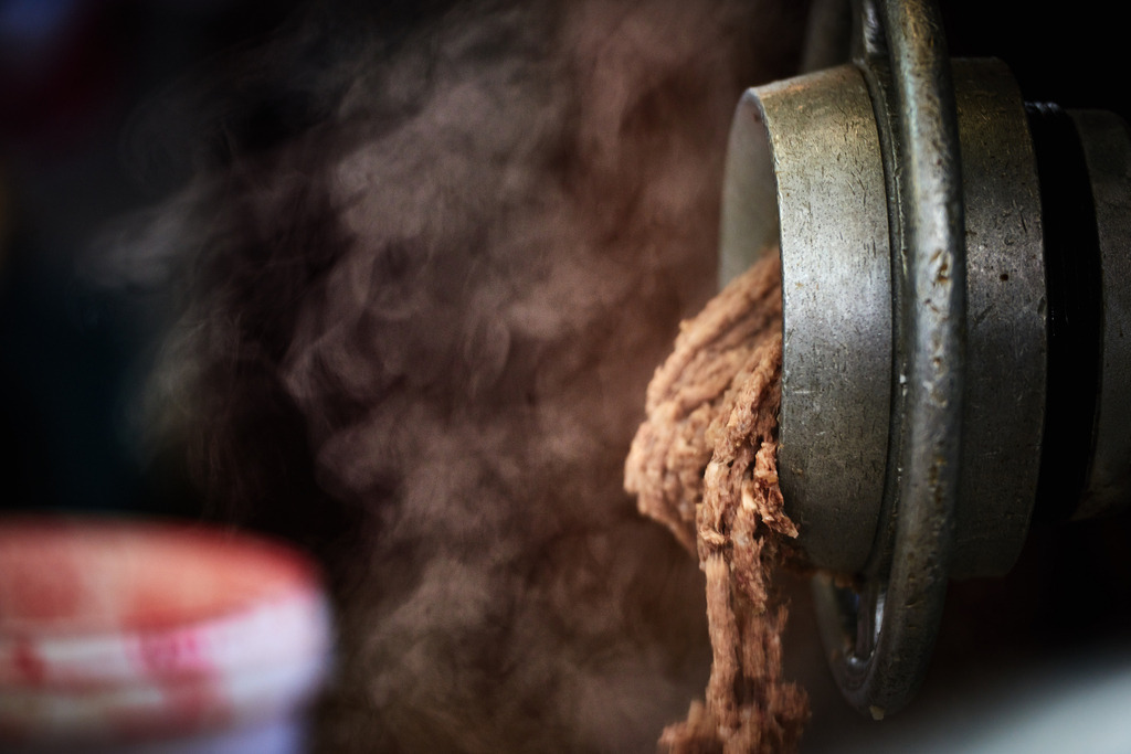 Fleischerei Dormayer | Langenzersdorf, Austria - February 12, 2019: Fleischerei Dormayer - Blutwurst Herstellung; aus dem Kutter kommt das Brät, im Hintergrund ein Eimer mit Blut. - Realisiert mit Pictrs.com