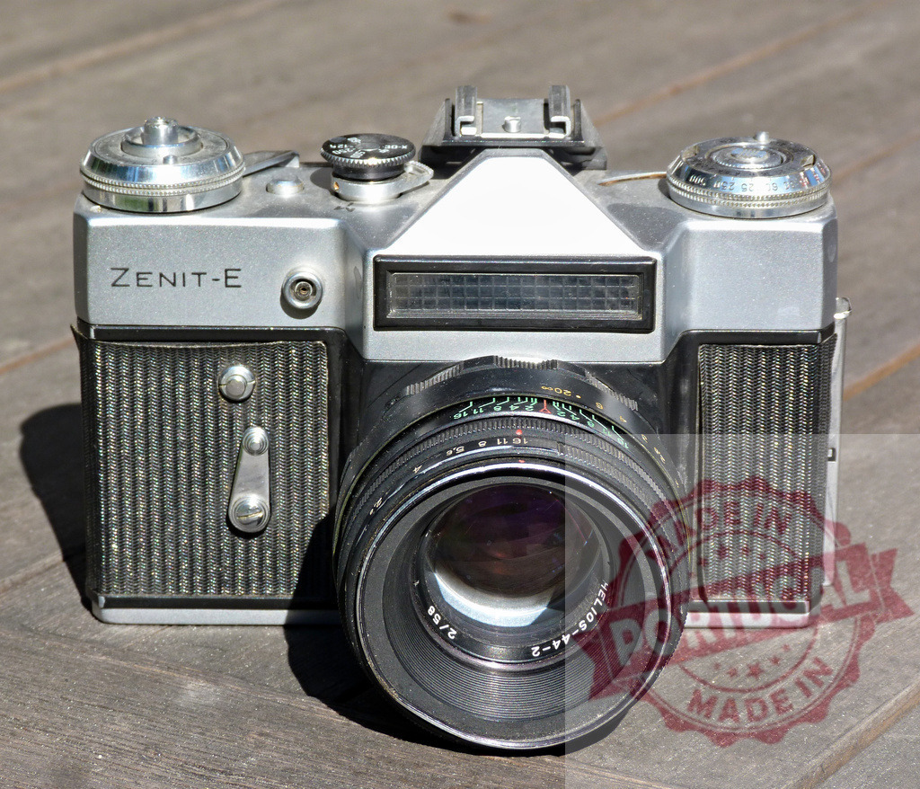 Zenit-E vintage 35mm film camera capturing analog photography | Zenit-E vintage 35mm film camera with Helios 44-2 lens on a wooden surface - Realized with Pictrs.com