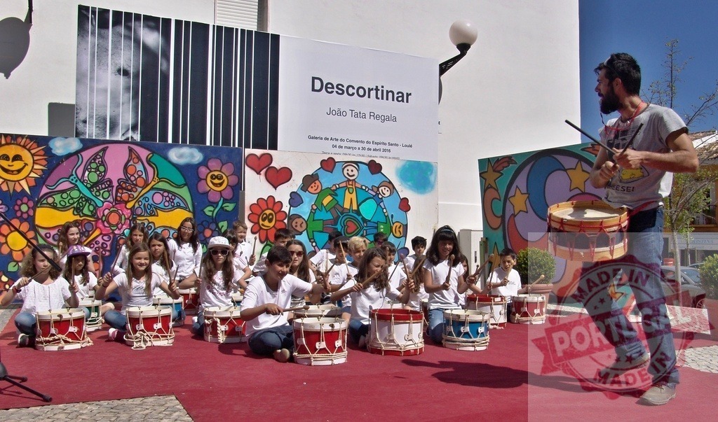 Children learning drumming from an instructor outdoors | Children are playing drums with an instructor during a street festival or workshop - Realized with Pictrs.com