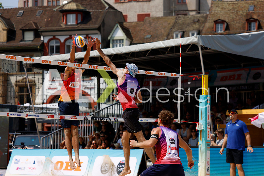 Obi BeachTour 2026 - Basel | BASEL, SWITZERLAND - JULY 19: SIMON HAGENBUCH (SUI) attack / spike LUC EMANUEL FLÜCKIGER (SUI) block during the Obi BeachTour 2026 match between DILLIER / FLÜCKIGER (SUI) and HAGENBUCH / HAUSSENER (SUI) at Barfüsserplatz on July 19, 2026 in Basel, Switzerland. - Realisiert mit Pictrs.com